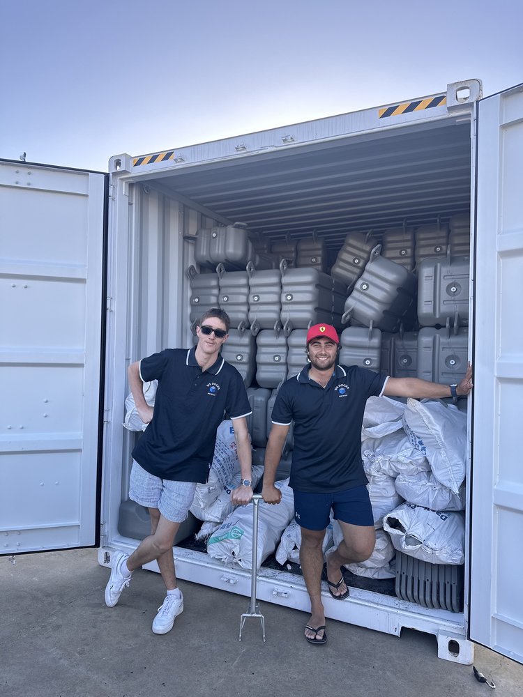 Image of Josh and Damian, founders of WS Docks, standing in front of container of docking materials