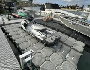 Floating jet ski dock with modular design, easy access ramp, and durable UV-resistant materials on a calm waterfront